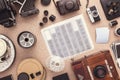 Many cameras roll of films, contacts on wooden cork table. Photographer workspace. Flat lay. View from above.