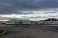 Many camper vans and RVs parked in the RV Park in the harbor at Port Barcares under an overcast sky