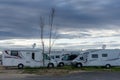 Many camper vans and RVs parked in the RV Park in the harbor at Port Barcares under an overcast sky