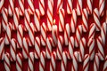 Many candy canes are lined up in a row created with generative AI technology