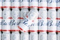 Many Cans of Budweiser Lager Alcohol Beer lies on grey background.