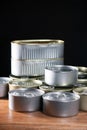 Many cans of canned tuna and sardine on brown wood