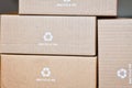 Cardboard boxes with recycling arrow symbol and text saying Recycle me Royalty Free Stock Photo