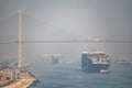 Many cargo ships navigate through Suez Cana andder Al Salam Bridge. Concept of transportation and logistics