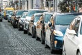 Many Cars parked in row on street in city in sunny summer day. ecological problem - air pollution Royalty Free Stock Photo