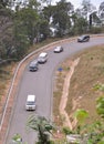 Many cars running on the countryside road