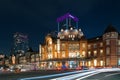 many cars and taxi are in front of JR Tokyo station at night with light from car movement by long exposure technique