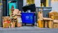 Many carton boxes and a blue renewi container, Garbage on the streets of antwerp city, Recycling concept, Antwerpen, Belgium,