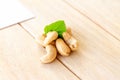 many cashew nut with green leaf on wooden table in studio Royalty Free Stock Photo