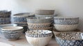 Many ceramic bowls with blue designs are stacked on shelf Royalty Free Stock Photo
