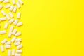 Many chewing gum pieces on yellow background, flat lay. Space for text