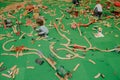 Many children assemble a designer on a green carpet.