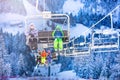 Many children on ski chairlift over snowy forest Royalty Free Stock Photo