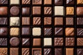 Many chocolate candies displayed in box. AI Generated