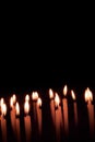 Many christmas candles burning at night on the black background Royalty Free Stock Photo