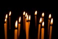 Many christmas candles burning at night on the black background Royalty Free Stock Photo