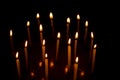 Many christmas candles burning at night on the black background Royalty Free Stock Photo