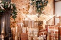 Many Christmas gifts. Winter home decor. Christmas in loft interior against brick wall. Royalty Free Stock Photo