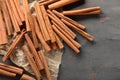 Many cinnamon sticks on grey background