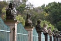 Row of busts on pillars in ancient fence Royalty Free Stock Photo