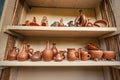 clay jugs are pressed on the shelf for drying. The concept of tableware and a useful hobby