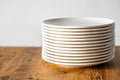 Many Clean white plates dishes kitchenwear on table Royalty Free Stock Photo