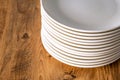 Many Clean white plates dishes kitchenwear on table Royalty Free Stock Photo