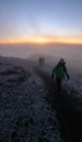 Many climbers and mountain guides arrive on the summit of Mount Kilimanjaro just after sunrise Royalty Free Stock Photo