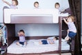 Many clone baby girls on bund bed in child room in domestic life. identical child crowd. Kid with different emotion