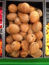 Many coconuts lying in a boxes in supermarket