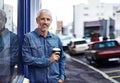 So many coffee shops to choose from. Portrait of a handsome mature man drinking takeaway coffee while out in the city. Royalty Free Stock Photo