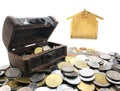 Many coins and mini Treasure Chest. Concept Save money for home lone on white background. Many type of coins and blur wooden Royalty Free Stock Photo