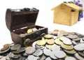 Many coins and mini Treasure Chest. Concept Save money for home lone on white background. Many type of coins and blur wooden Royalty Free Stock Photo