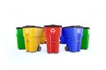 Many color plastic garbage bins with recycling logo.