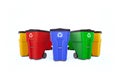 Many color plastic garbage bins with recycling logo.