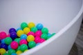 Colored balls are in the white water bath Royalty Free Stock Photo