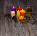 Many colored candles and cones on old wooden background Royalty Free Stock Photo