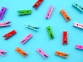 many colored clothespins on a blue background, as a substrate, pin clothes peg Royalty Free Stock Photo