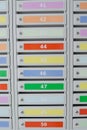 Many colored letterboxes in the building, vertical photo. Communication concept