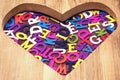 Many Colored Letters In The Wooden Heart Shape Royalty Free Stock Photo