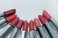 Many colored lipsticks lie in a semicircle