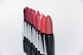 many colored lipsticks lie in a semicircle