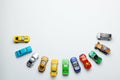 Many colored little toy cars on a gray background Royalty Free Stock Photo