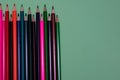 Many colored pencils lie on a green background. Copy spase. The concept of back to school, the educational process, study at Royalty Free Stock Photo