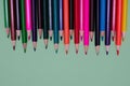 Many colored pencils lie on a green background. Copy spase. The concept of back to school, the educational process, study at Royalty Free Stock Photo