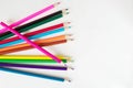 Many colored pencils lie on a white background. Copy spase. The concept of back to school, the educational process, study at Royalty Free Stock Photo