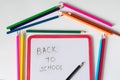 Many colored pencils lie on a white background. Copy spase. The concept of back to school, the educational process, study at Royalty Free Stock Photo