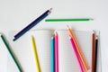 Many colored pencils lie on a white background. Copy spase. The concept of back to school, the educational process, study at Royalty Free Stock Photo