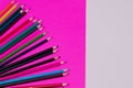 Many colored pencils lie on a white-pink background. Copy spase. The concept of back to school, the educational process, study at Royalty Free Stock Photo