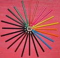 Many colored pencils on a pink background Royalty Free Stock Photo